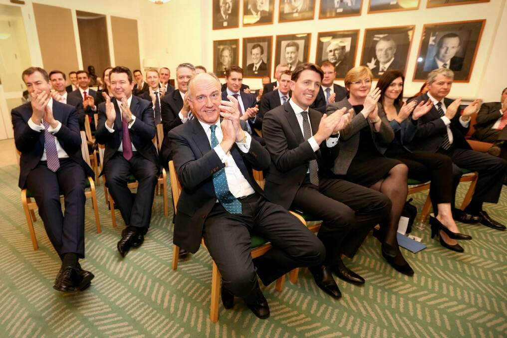 Coalition MPs applaud during a meeting at Parliament House on Monday. Photo: Alex Ellinghausen