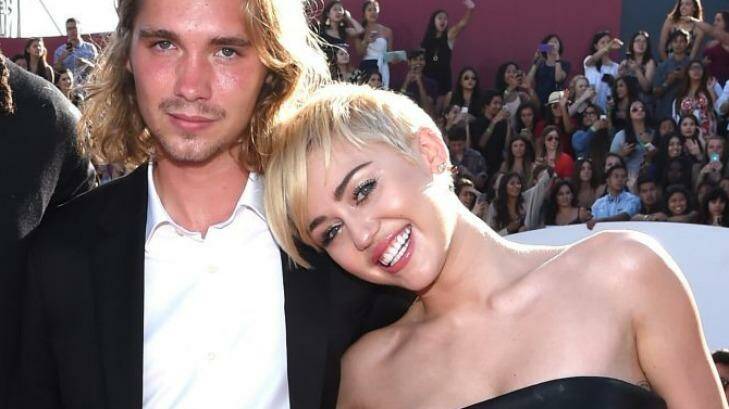 Triumph: Miley Cyrus with her mystery date, Jesse. Photo: Getty Images