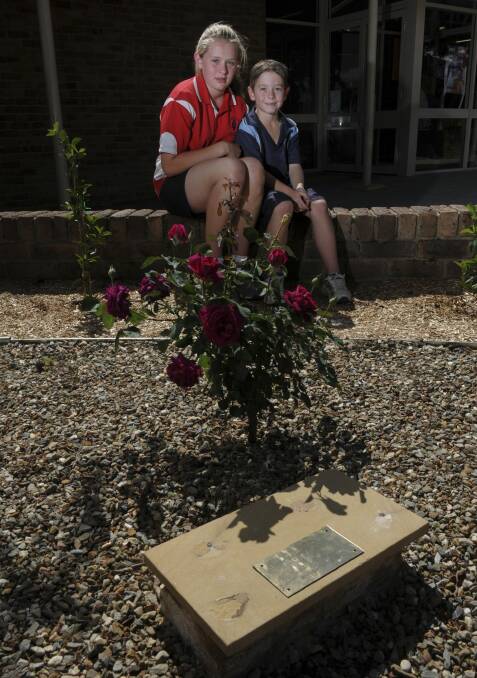 Abbie's older sister, Micaela Mewburn, 12, of Monash and one of Abbie's school friends Lucas Ryan, 7, of Isabella Plains at the memorial. Photo: Graham Tidy.