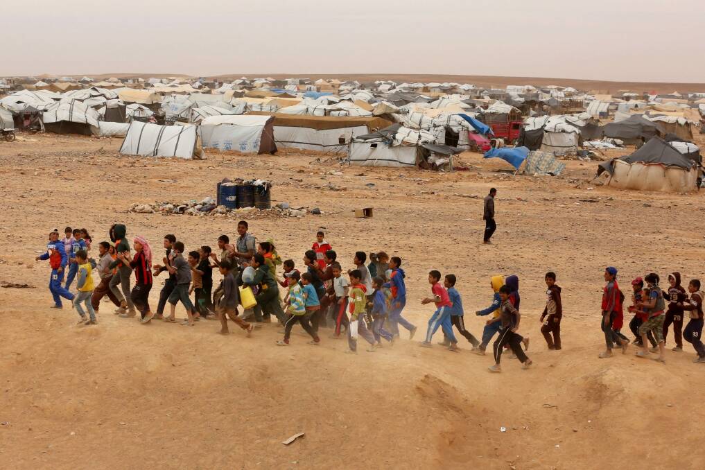 Syrian refugee boys await approval to enter Jordan. Photo: AP