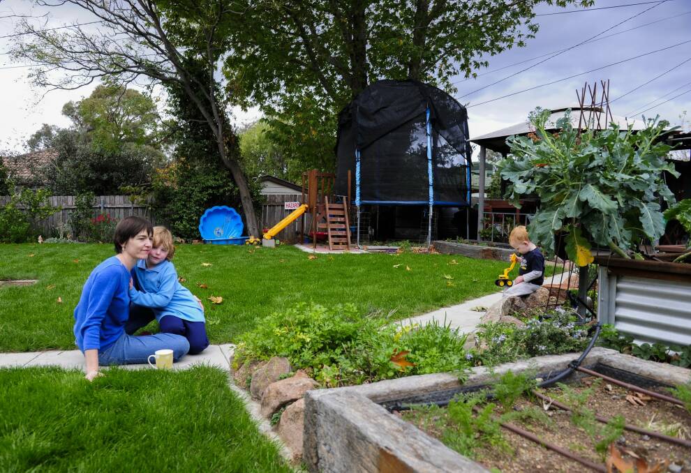 Suzanne Pippen with her children Hannah, 4, and Dominic, 2, in their Duffy back yard, worried about being built out by dual occupancies that will be allowed on Fluffy blocks. Photo: Melissa Adams