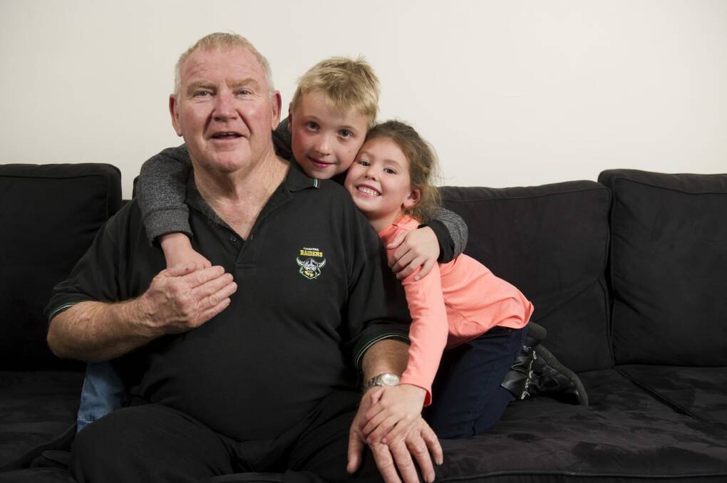 John Nicholson who has early onset dementia with his grandchildren Lincoln, 8, and Zara Nicholson. Photo: Jay Cronan