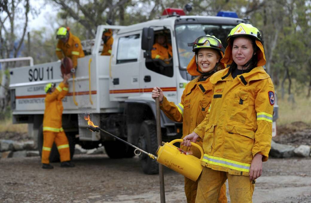 Hannah Burggraaff and Kaylea Boulter of the Southern ACT Bushfire Brigade. Firefighters will continue performing hazard reduction burns into winter and spring.  Photo: Graham Tidy