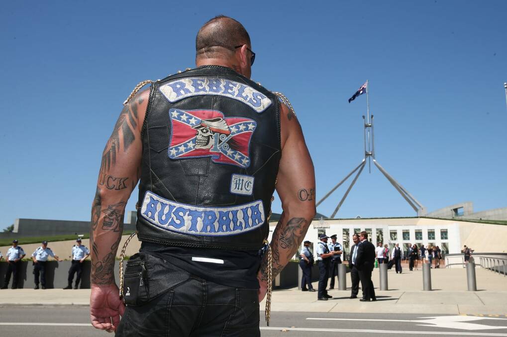 A patched Rebels member who was among riders protesting bikie laws at Parliament House in Canberra in December 2014.  Photo: Alex Ellinghausen