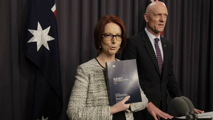 Prime Minister Julia Gillard refers to the 2013 Budget papers with Minister for School Education Peter Garrett during a press conference at Parliament House on Sunday. Photo: Andrew Meares