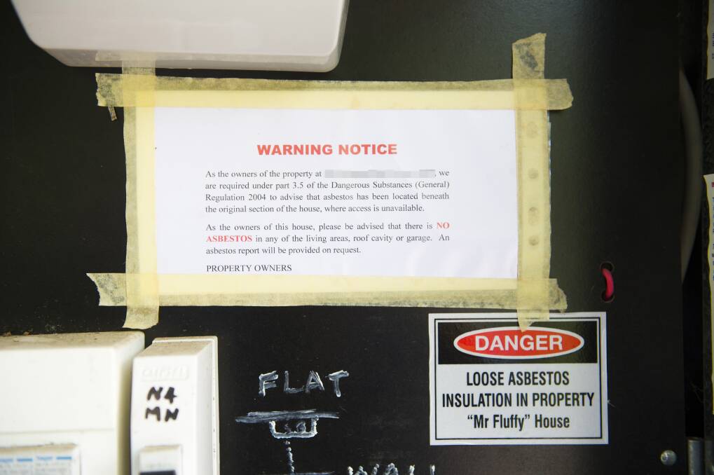Lorraine Carvalho has placed her own Mr Fluffy warning notice in the electricity meter box at her home, informing visitors that there is no Mr Fluffy contamination in the living areas. Photo: Dion Georgopoulos