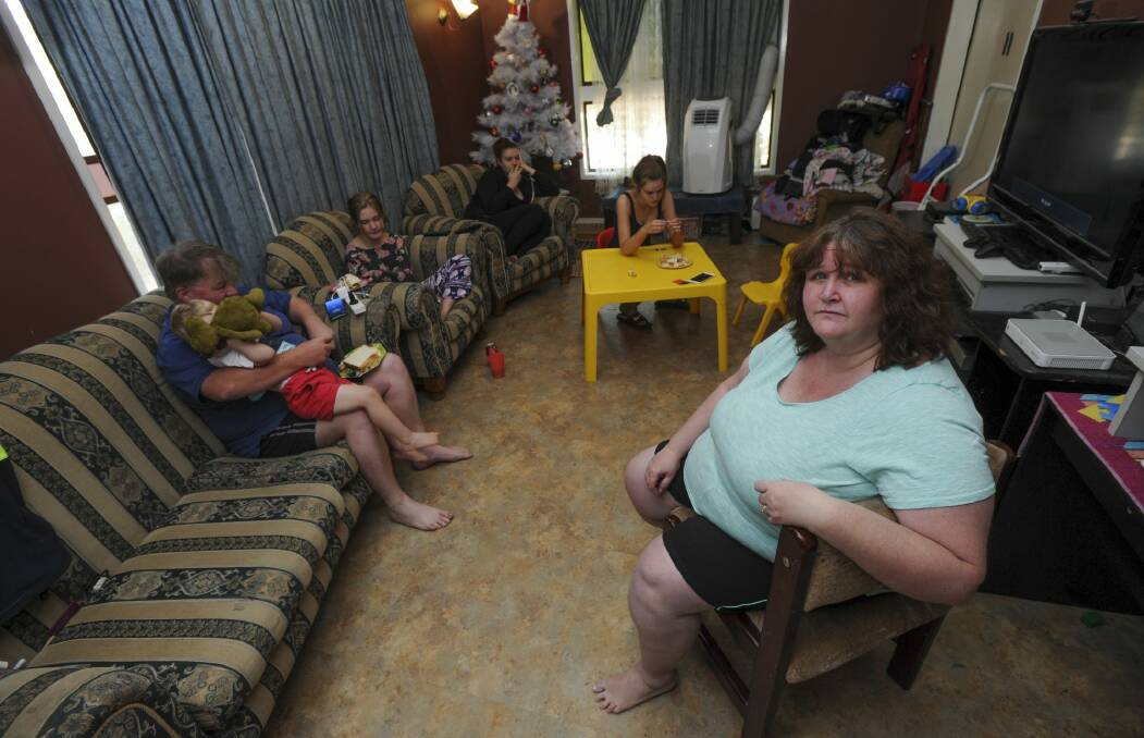 The Muller family eat in the lounge room of their ACT government home in Stirling because one daughter sleeps in the dining room. Photo: Graham Tidy
