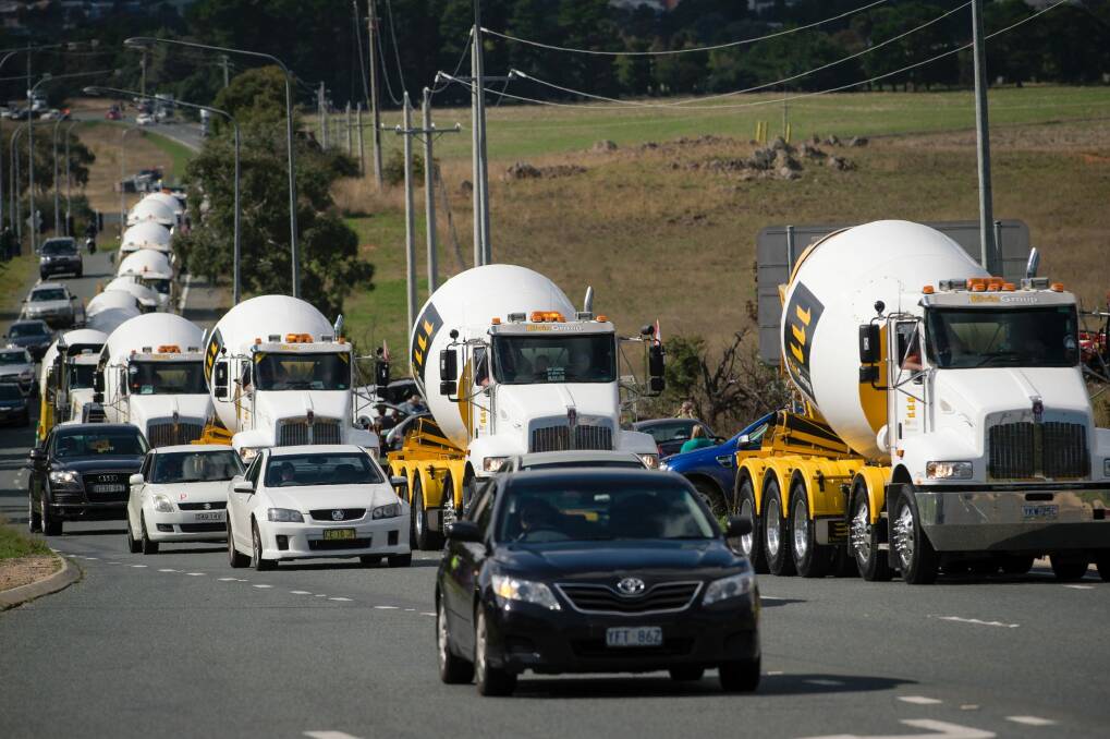 Trucks in the 2017 Convoy for Cancer drive up Canberra Avenue. Photo: Sitthixay Ditthavong