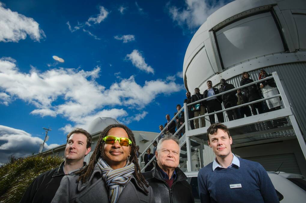 Researchers Paul Sibley, Moriba Jah, Ben Greene and Michael Copeland gather in front of Mount Stromlo's satellite laser station.  Photo: Sitthixay Ditthavong