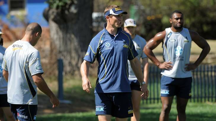 Team focus ... Stephen Larkham drills the Brumbies back line as preparations come to a head for their Super Rugby opener against Quade Cooper and the Queensland Reds. Photo: Graham Tidy
