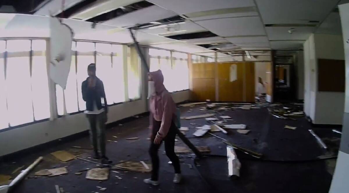 Teens inside the former CSIRO office block, now abandoned. Photo: Sherryn Groch