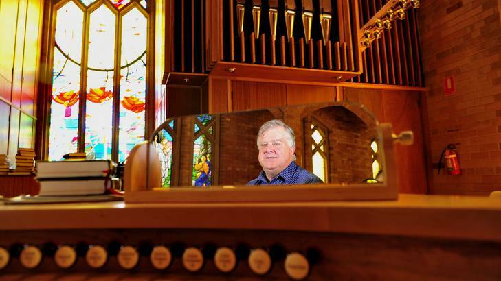 Chris Erskine is as excited as a boy with a new toy with the grand new organ at Saint Paul's Anglican church, Manuka. Photo: Melissa Adams