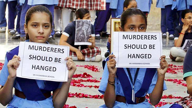 Call for the death penalty ... schoolgirls in Ahmadabad hold placards during a prayer ceremony to mourn the death of the rape victim. Photo: AP