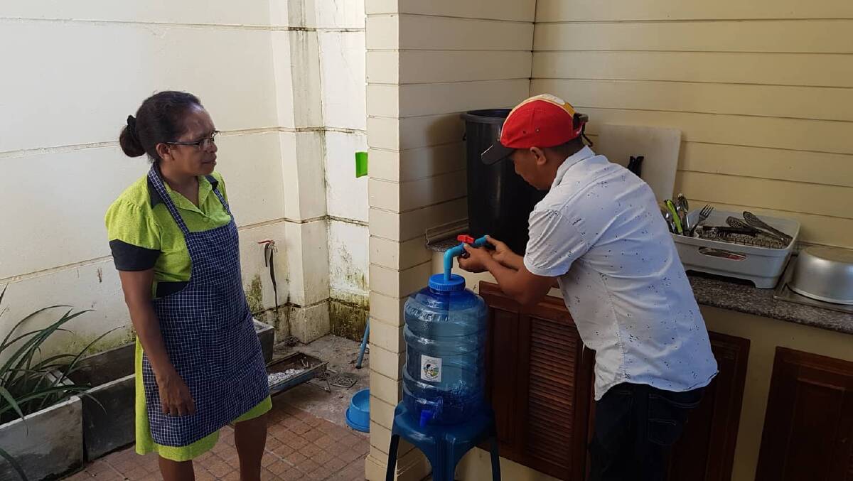 Timorese trainee Joanico Da Silva installing a water filter at the home of the Ambassador to East Timor in Laos, Natália Carrascalão. Photo: Supplied