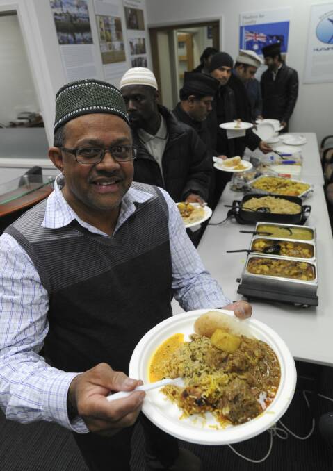 Association president Mohammad Hasan begins the feast.  Photo: Graham Tidy