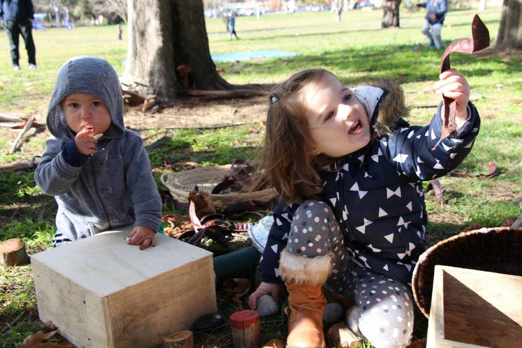 Two Canberra children enjoy playing outside at the Nature Play CBR launch on Thursday. Photo: Supplied