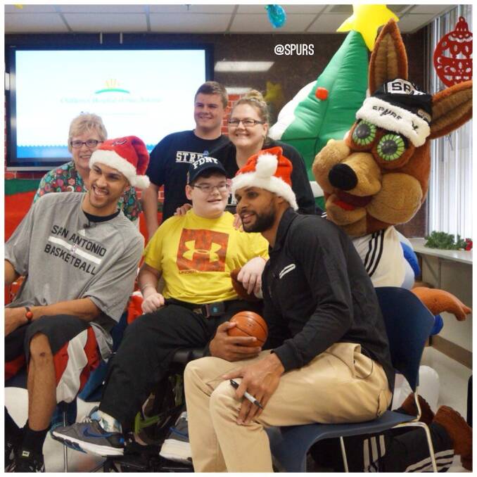 NBA star Patty Mills cheering up some kids in a San Antonio hospital.