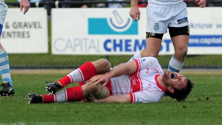 Tuggeranong's captain, Gareth Clouston in agony on the field.  Photo: Graham Tidy