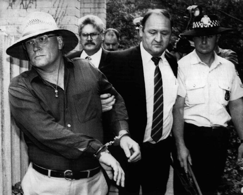 Commander Rick Ninnes leads David Eastman away from his Reid home after his arrest on December 23,  1992 for the murder of Colin Winchester. Eastman's subsequent conviction was quashed on Friday.