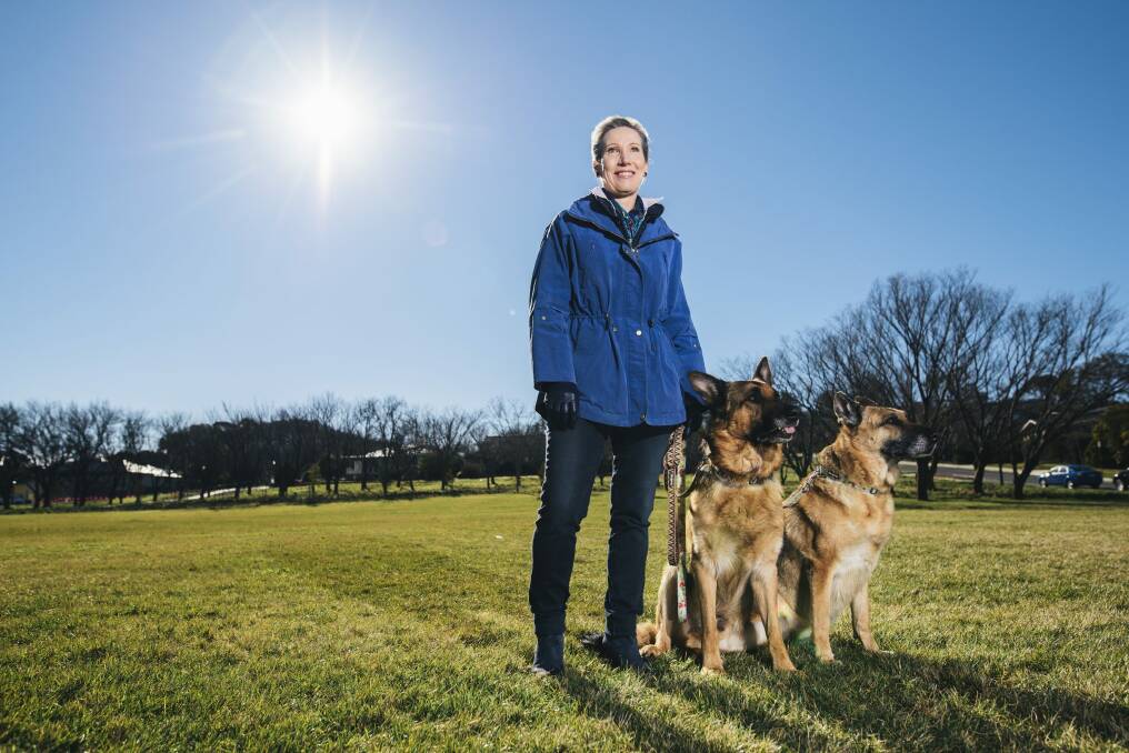 Sandra Hassett with her dogs in the new Hassett Park in Campbell. The park has been named after her father, General Sir Francis Hassett. Photo: Rohan Thomson