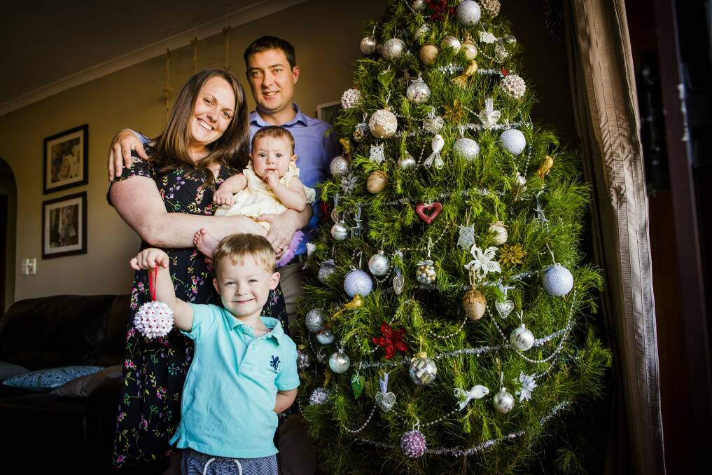 Mr Fluffy home owners unexpectedly had a Christmas Tree donated to them from the Christmas Tree Truck. Lisa and her husband Andrew Ziolkowski, and their children Natalie 9-months-old, and Jonathan 3-years-old. Photo: Jamila Toderas
