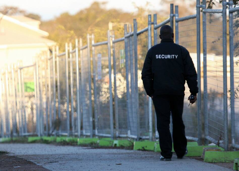 A security guard in Canberra: People with no hope of getting security work are being put through the cost and time of qualifying. Photo: Jeffrey Chan