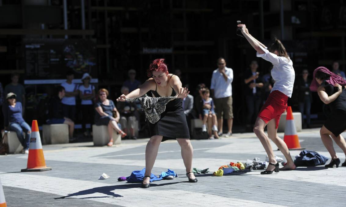 Performance artists Alison Plevey, centre, Olivia Fyfe, left, and Debora Di Centa during the Spout dance performance in the middle of Phillip Law Street on Saturday. Photo: Graham Tidy