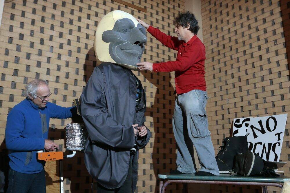 From left, concept instigator Matthew Armstrong, performer Hemlock Mejarne (masked) and director Robin Davidson work on the final touches on a Tony Abbott puppet.  Photo: Jeffrey Chan