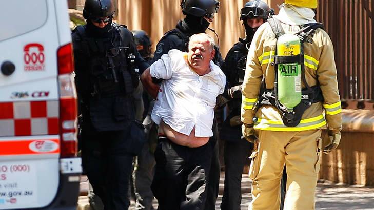 Abdula Ganiji is placed under arrest by tactical police outside NSW Parliament House on Maquarie Street. Photo: Brendon Thorne