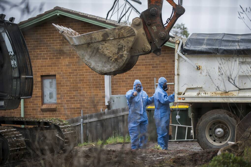 Workers demolish a Mr Fluffy home in Woden Valley, ACT, in 2014. Photo: Rohan Thomson