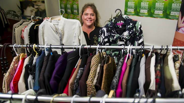 Maree Miller, past client, and now volunteer of the communities at work program, with some of the clothes donated by Labor MPs. Photo: Rohan Thomson
