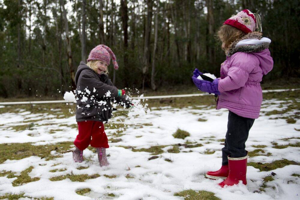 Eleanor Passlow and Alexandra Wright enjoying the snow at Corin Forest recreation park. Photo: Jay Cronan