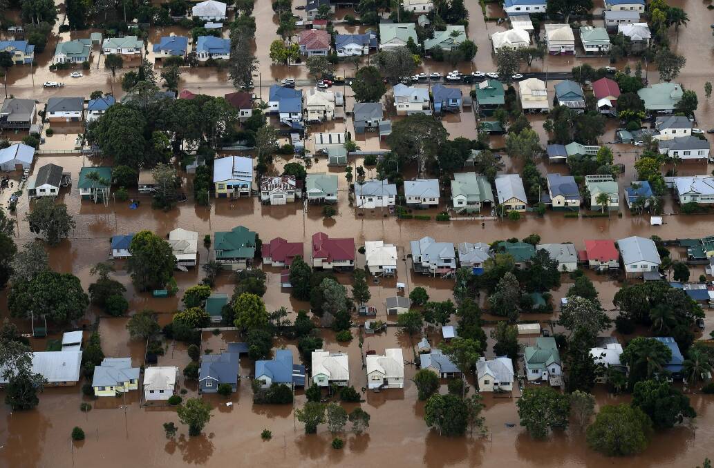 Floodwaters from the Wilsons River engulf homes in central Lismore. Photo: Dave Hunt