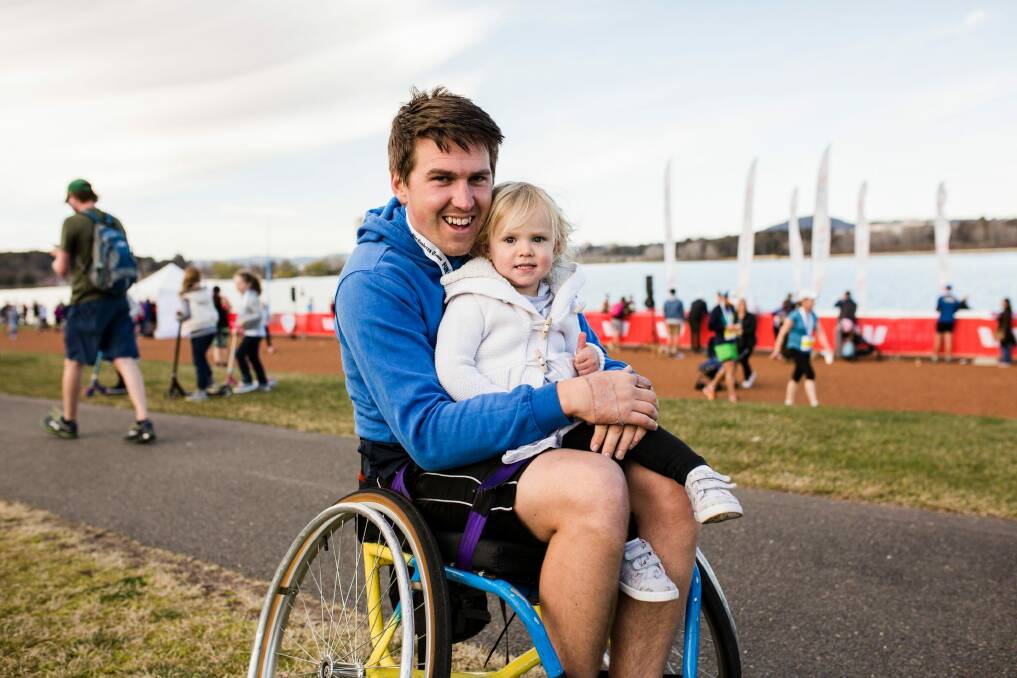 Macgregor's Rohan Foy with his daughter Harper, two, after completing the 14-kilometre race.  Photo: Jamila Toderas