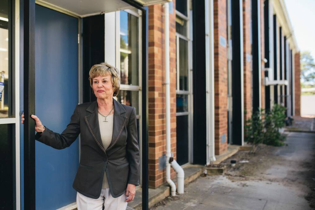 Narrabundah College principal Kerrie Grundy with one of the buildings set to be demolished due to asbestos contamination. Photo: Rohan Thomson