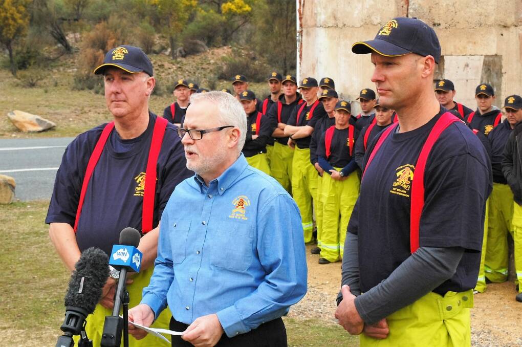 Veteran Canberra firefighters Commander Stephen Gibbs, left, and Station Officer Sam Evans, right, with ACT United Firefighters Union secretary Greg McConville at the launch of the Rescue Canberra's Future campaign on Wednesday. Photo: David Ellery