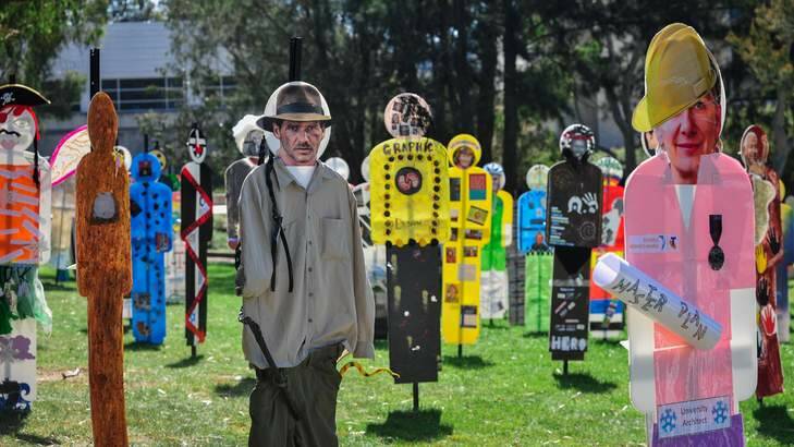 A forest of life-sized corflute figures representing the people who've made the University of Canberra unique over its 45-year history. Photo: Katherine Griffiths