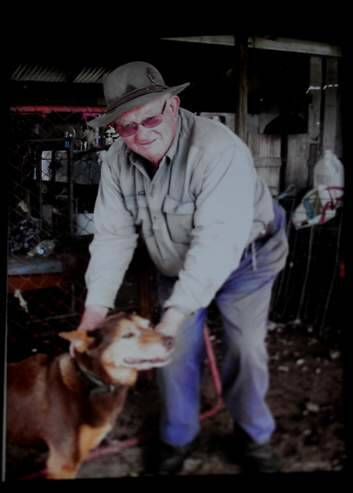 Former owner Lionel Coffey with his dog hanging in the old milking shed. Mr Coffey died earlier this year. Photo: Melissa Adams