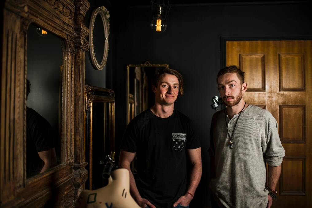 Michael Wilkinson, and Mitch Young in one of their escape rooms.