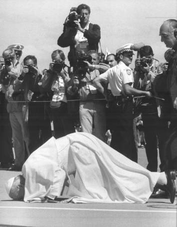 The Pope kisses the ground on his arrival. Photo: Supplied