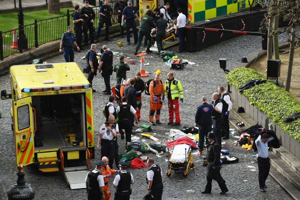 Emergency services at the scene of the attack outside the Palace of Westminster, London. Photo: PA