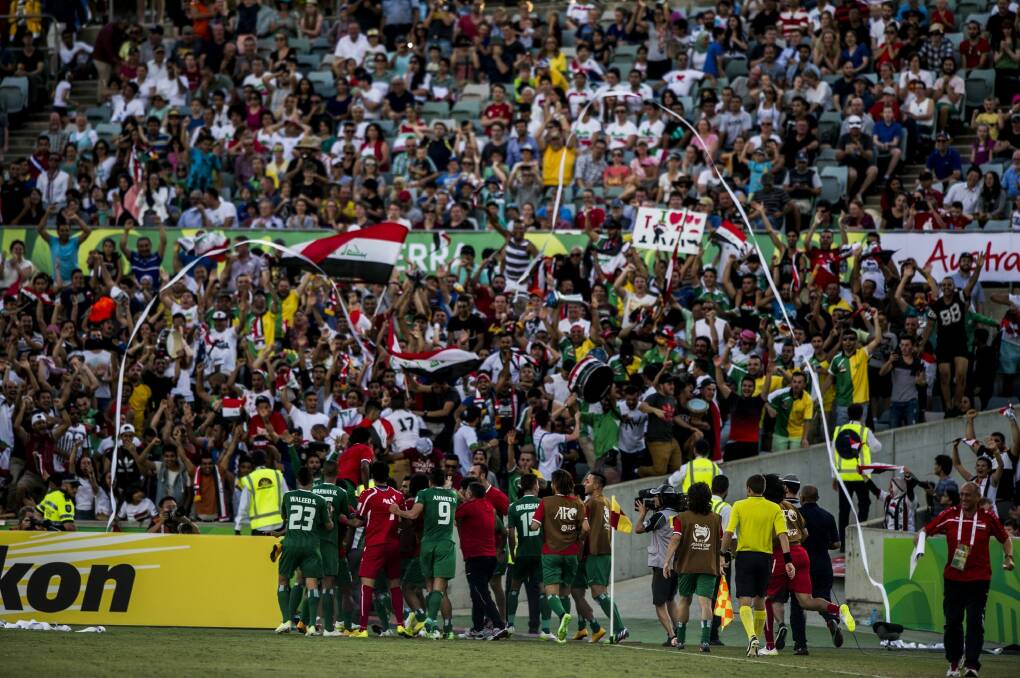 Great stadium, electric atmosphere: Iraq celebrate scoring a goal during extra time against Iran. Photo: Jay Cronan