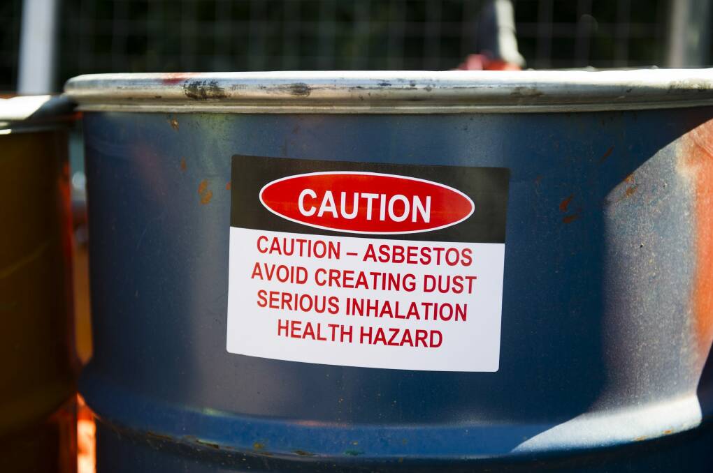 Drums used to seal Fluffy asbestos and workers' suits in Kambah. Photo: Rohan Thomson