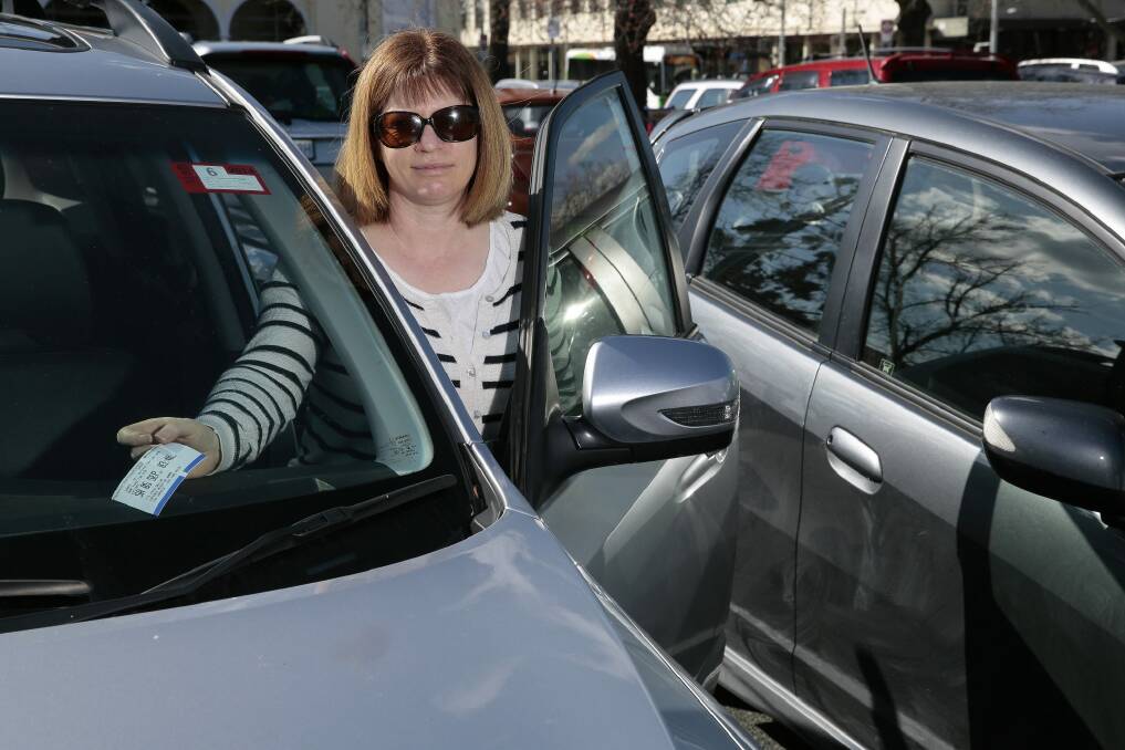 Joanne Palisi of Hughes pays for parking on Saturday afternoon at the carpark of the Canberra Museum and Art Gallery.  Photo: Jeffrey Chan