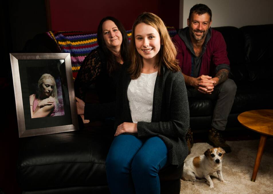 Kira Dart with a photo of her late mother, Bianca, aunt Carolyn Hullick and mental health advocate James Francis, a volunteer with the Black Dog Institute. Photo: Elesa Kurtz