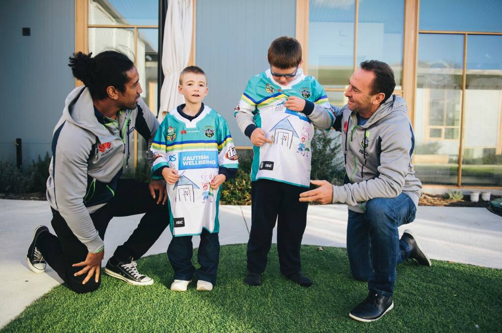Sia Soliola and Ricky Stuart meet with Jayden, 8, and Max, 12, to give them the special jerseys they helped design. Photo: Rohan Thomson