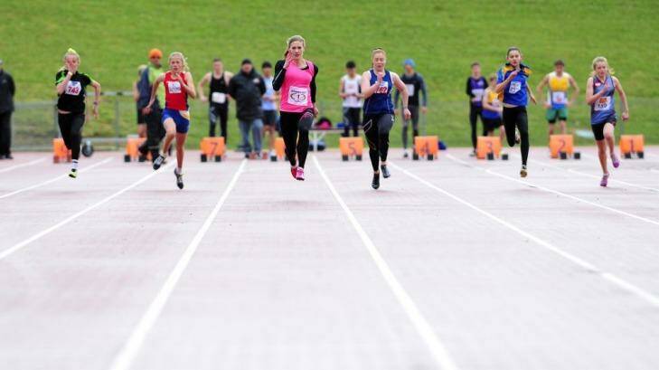 Melissa Breen, centre, ran an impressive 11.35 seconds in wet conditions at the AIS on Sunday. Photo: Jeffrey Chan