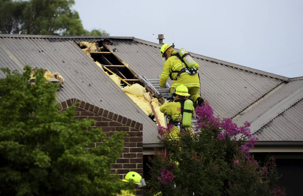 Lightning struck the gas line at this house in Dunlop, causing a fire in the roof. Photo: Graham Tidy