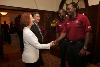 Prime Minister Julia Gillard and her partner Tim Mathieson greet West Indies cricket player Chris Gayle at The Lodge. Photo: Alex Ellinghausen