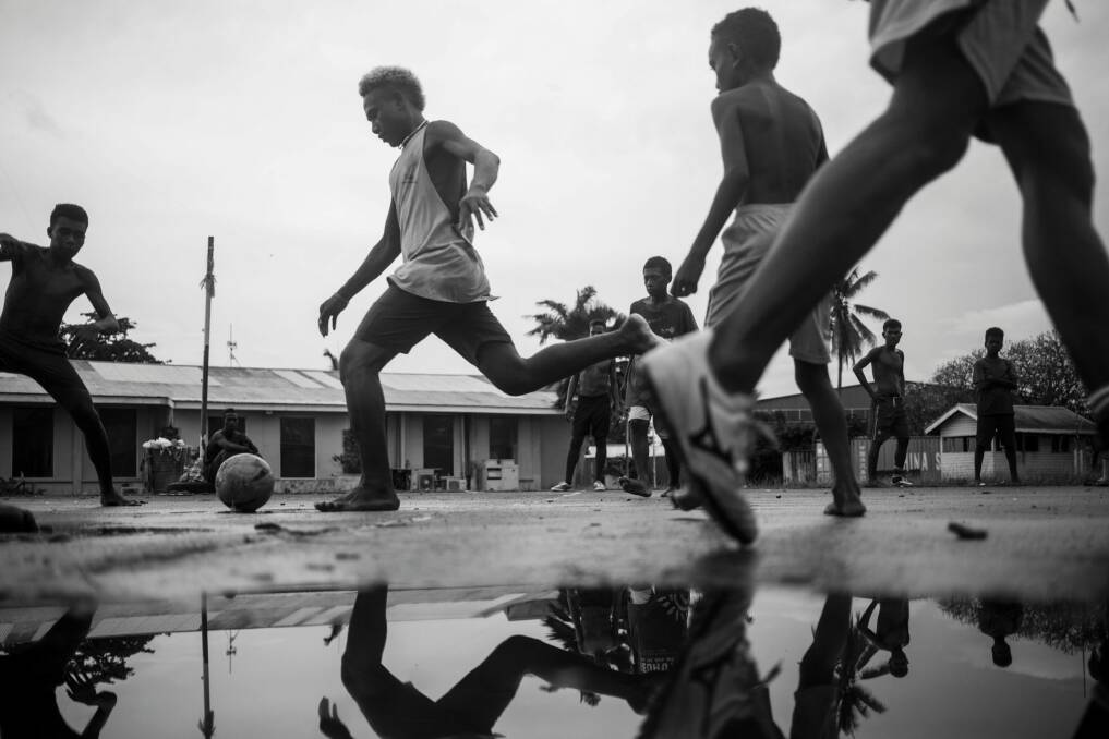 Sean Davey, Boys play a game of park soccer in Honiara, 2017, in Next Generation: Solomon Islands After RAMSI at Photoaccess. Photo: Sean Davey